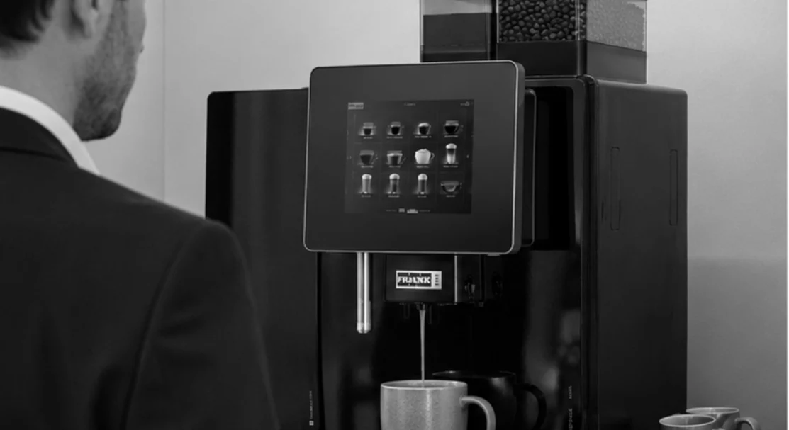 Person using a Ventra coffee machine in an office setting