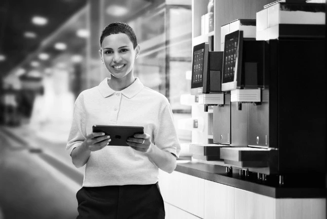 Ventra staff member servicing a machine with a tablet