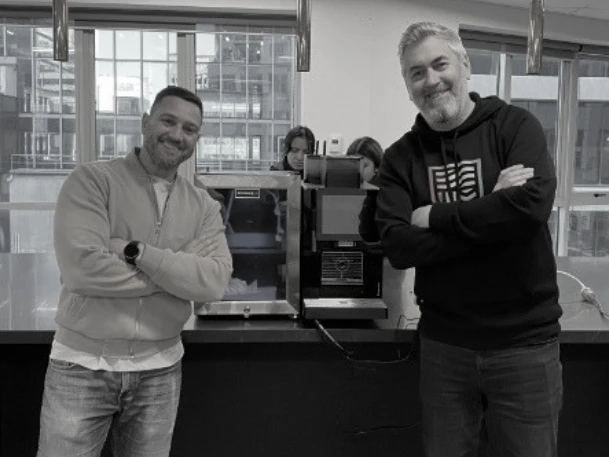 Andrew Knight, Campus Director and Principal at Charles Sturt University Sydney and Melbourne, with Claudio Da Rocha, Founder and CEO of Ventra, beside the new Franke coffee machine on campus.